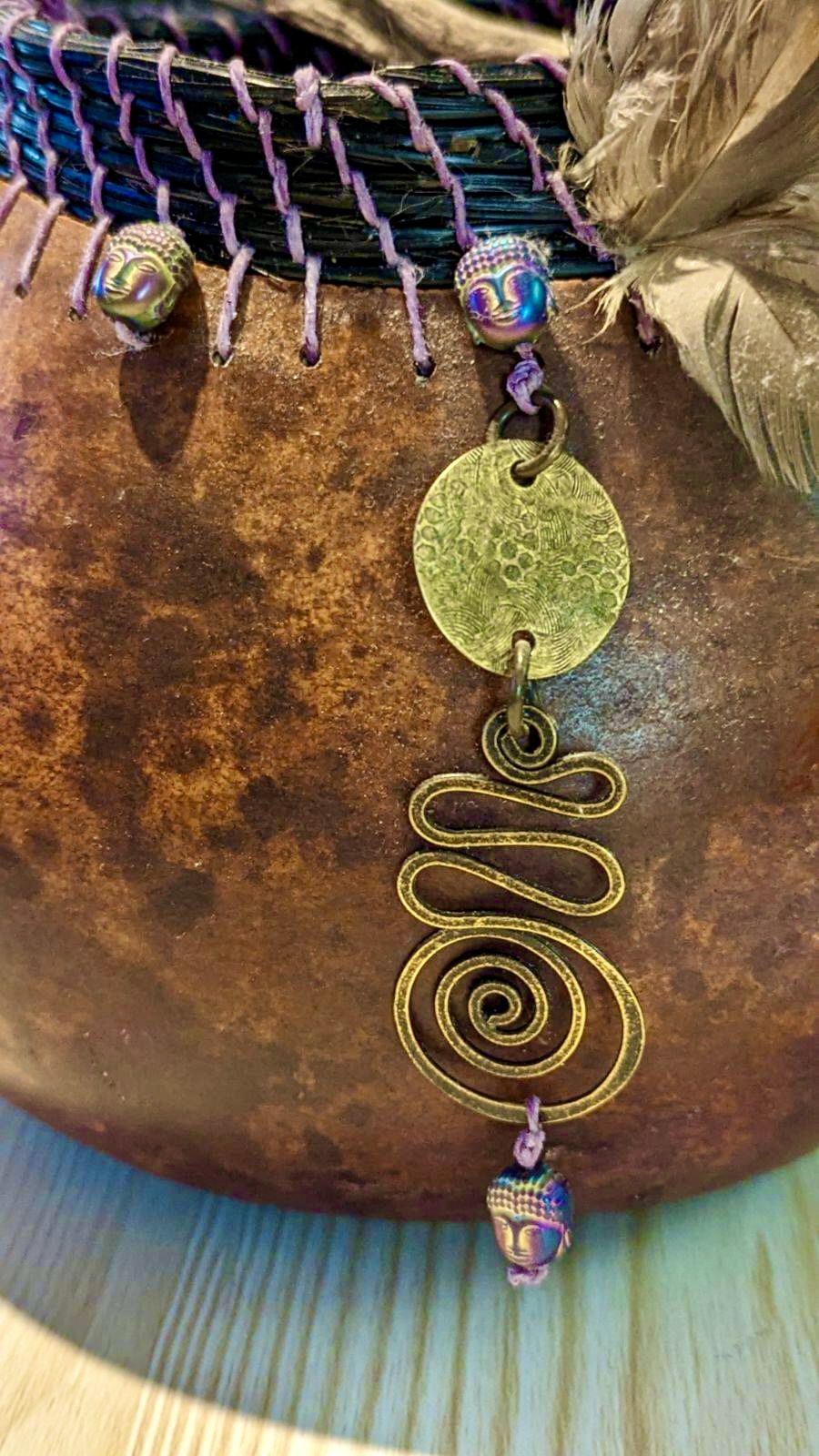 Espresso with Buddha head beads close up